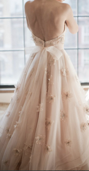 Adorable wedding dress with blush accents. via StyleMePretty.com