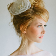 The ballerina bun will never go out of style. Pair it with a dramatic piece like this for an uptown wedding. Source: BridalGuide.com
